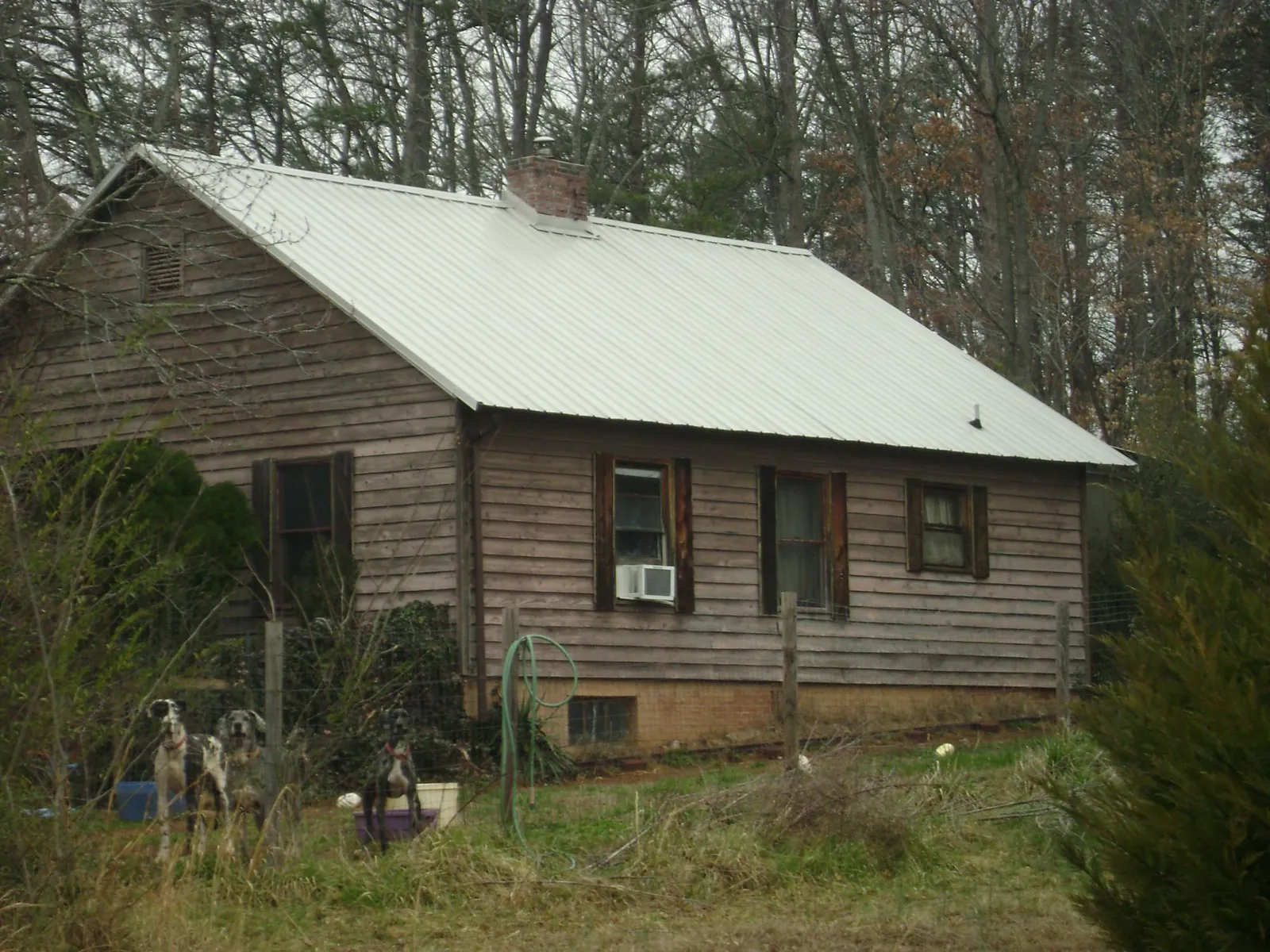 White metal roof on an old wood sided farmhouse, from a Asphalt Shingle Roof Repair job in Wilmington